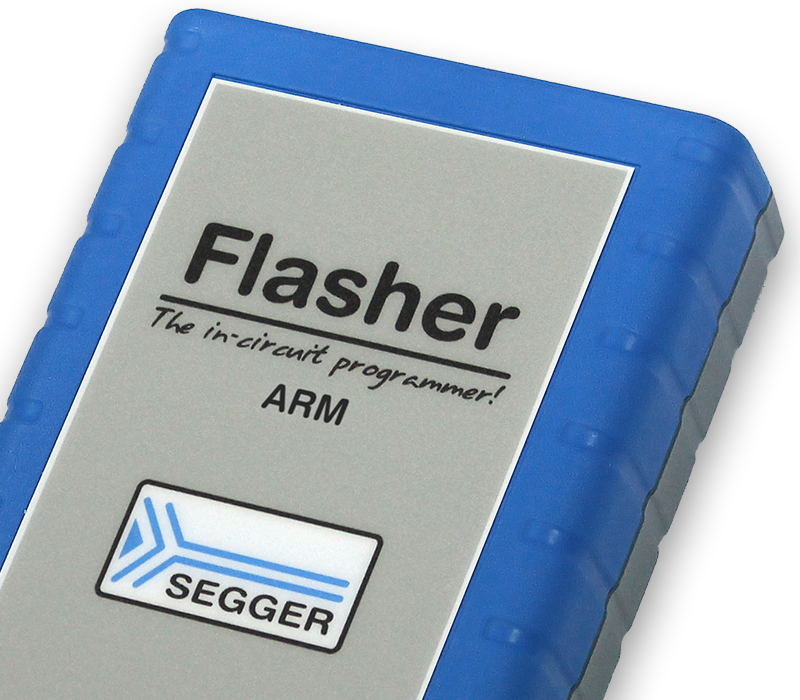 Image of a rectangular device labeled "Flasher" with the tagline "The in-circuit programmer!" and "ARM". The device has a gray front with rounded edges and a blue rubber case, along with a logo indicating "SEGGER" at the bottom.